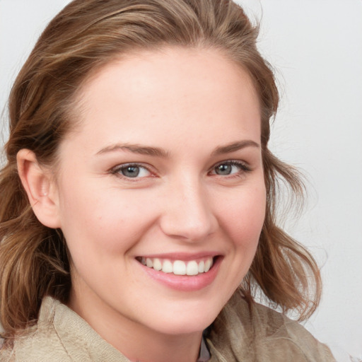 Joyful white young-adult female with medium  brown hair and blue eyes