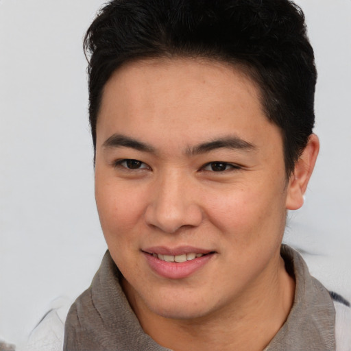 Joyful latino young-adult male with short  brown hair and brown eyes