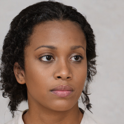 Neutral black young-adult female with medium  brown hair and brown eyes