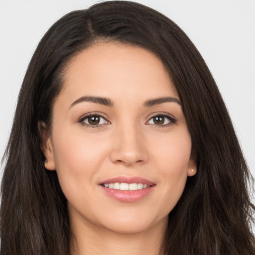 Joyful white young-adult female with long  brown hair and brown eyes