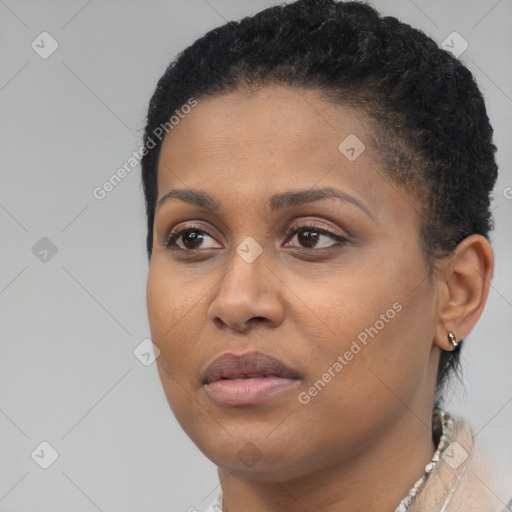 Joyful black young-adult female with short  brown hair and brown eyes