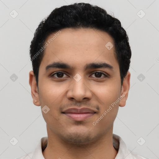 Joyful latino young-adult male with short  black hair and brown eyes