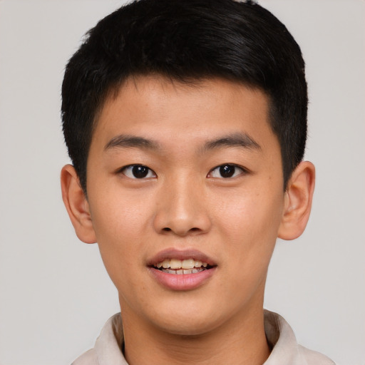 Joyful asian young-adult male with short  brown hair and brown eyes
