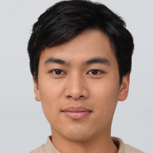 Joyful asian young-adult male with short  black hair and brown eyes