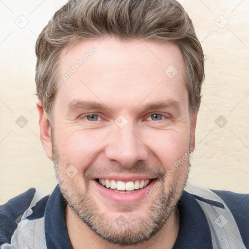 Joyful white adult male with short  brown hair and grey eyes