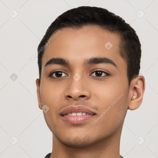 Joyful latino young-adult male with short  black hair and brown eyes