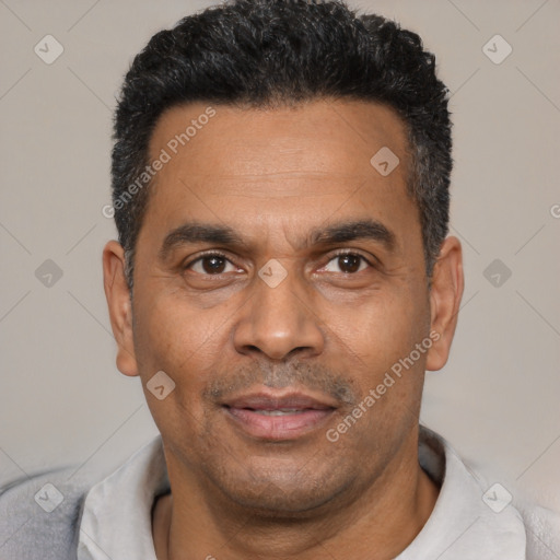 Joyful latino adult male with short  black hair and brown eyes