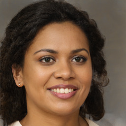 Joyful black young-adult female with medium  brown hair and brown eyes