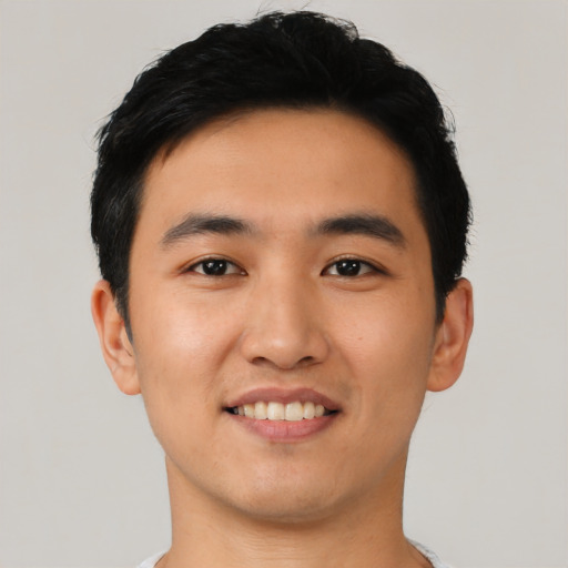 Joyful asian young-adult male with short  black hair and brown eyes