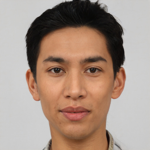 Joyful asian young-adult male with short  black hair and brown eyes