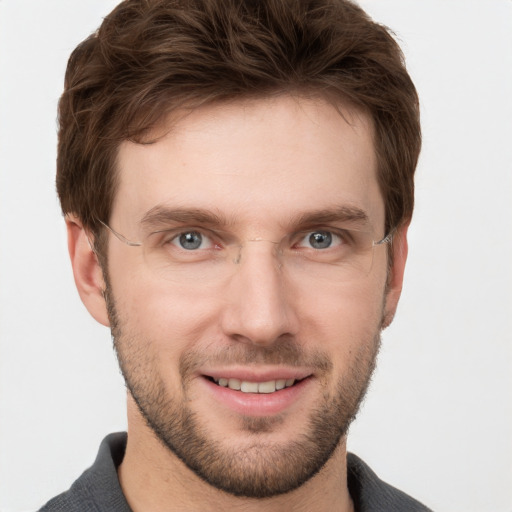 Joyful white young-adult male with short  brown hair and grey eyes