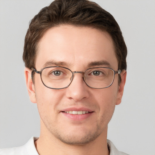 Joyful white adult male with short  brown hair and grey eyes