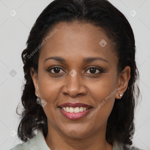 Joyful black adult female with medium  brown hair and brown eyes