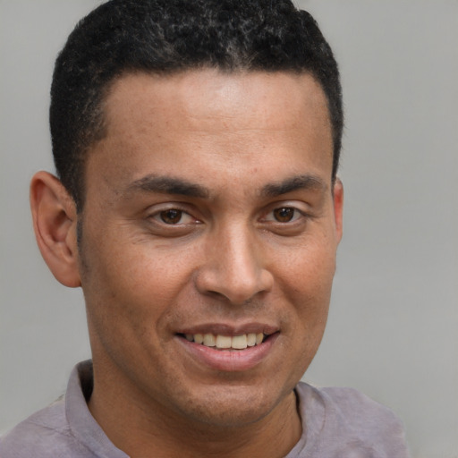 Joyful latino adult male with short  brown hair and brown eyes