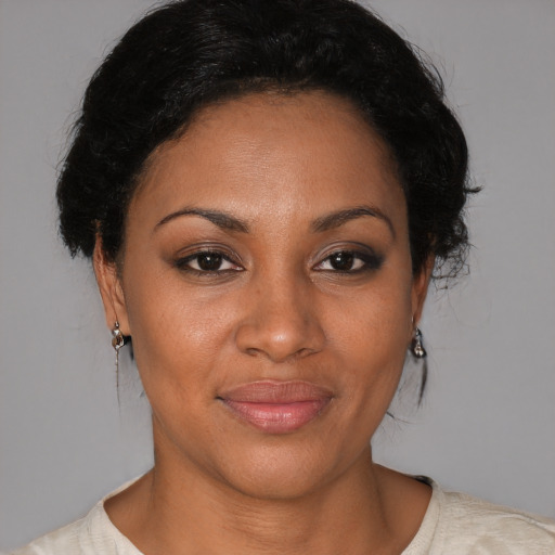 Joyful black adult female with short  brown hair and brown eyes