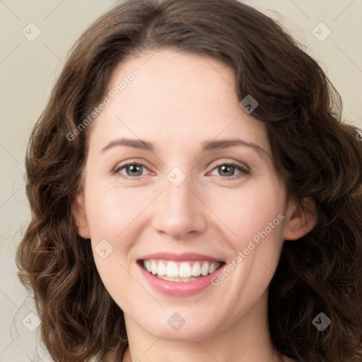 Joyful white young-adult female with long  brown hair and green eyes