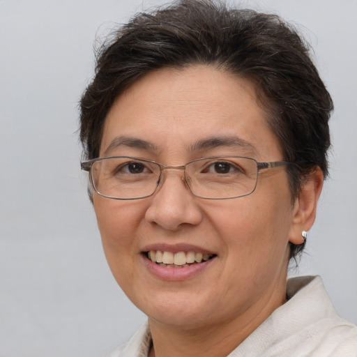 Joyful white adult female with short  brown hair and brown eyes