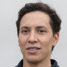 Joyful white adult male with short  brown hair and grey eyes