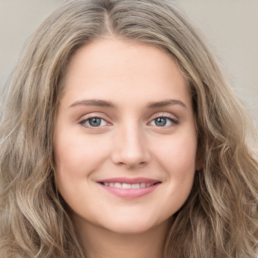 Joyful white young-adult female with long  brown hair and green eyes