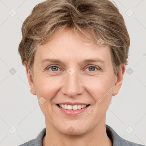 Joyful white adult female with short  brown hair and grey eyes