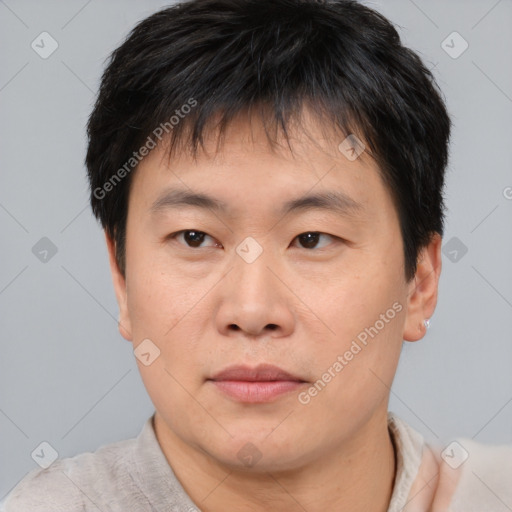 Joyful asian young-adult male with short  brown hair and brown eyes