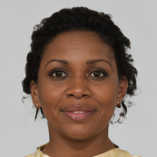 Joyful black adult female with short  brown hair and brown eyes