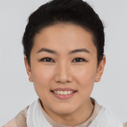 Joyful asian young-adult female with short  black hair and brown eyes