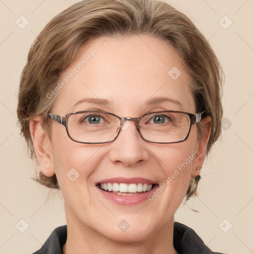 Joyful white adult female with medium  brown hair and grey eyes