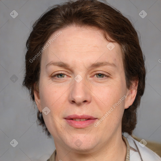 Joyful white adult female with medium  brown hair and grey eyes