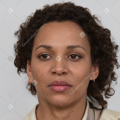 Joyful black adult female with medium  brown hair and brown eyes