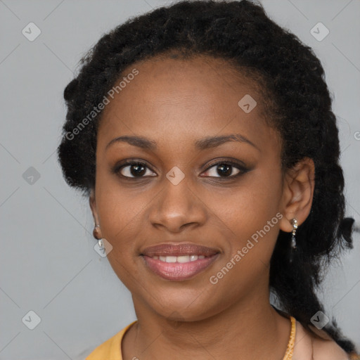 Joyful black young-adult female with long  black hair and brown eyes