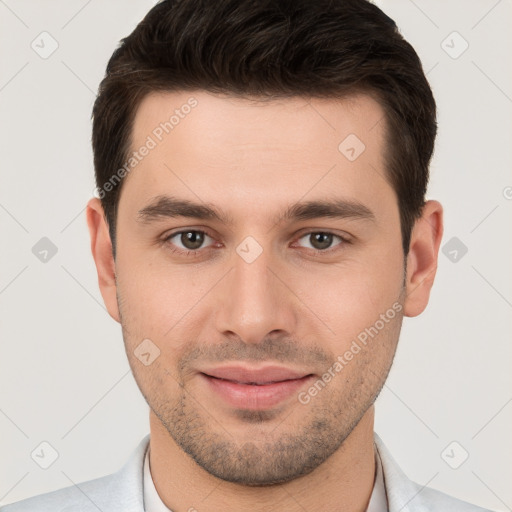 Joyful white young-adult male with short  brown hair and brown eyes