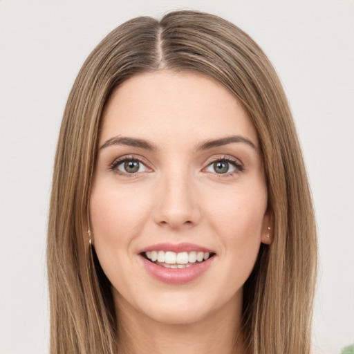 Joyful white young-adult female with long  brown hair and green eyes