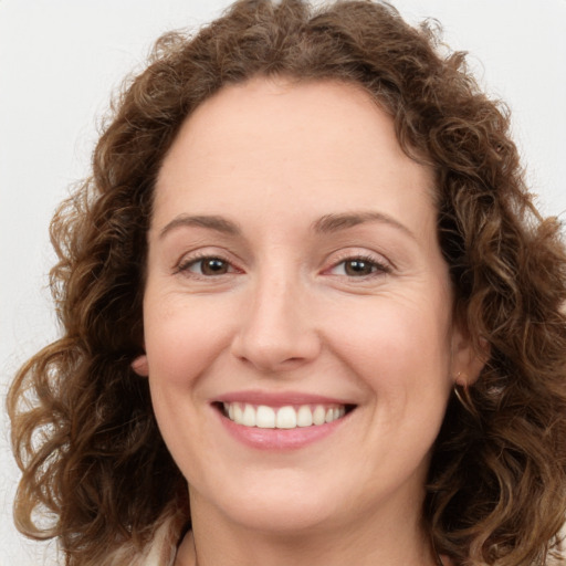 Joyful white young-adult female with long  brown hair and green eyes