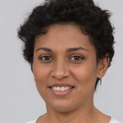 Joyful latino young-adult female with short  brown hair and brown eyes