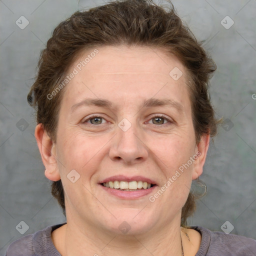 Joyful white adult female with short  brown hair and grey eyes