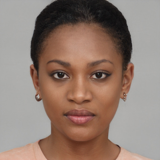 Joyful black young-adult female with short  brown hair and brown eyes