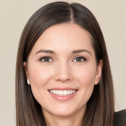 Joyful white young-adult female with long  brown hair and brown eyes