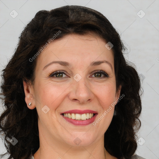 Joyful white adult female with medium  brown hair and green eyes