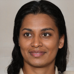 Joyful black young-adult female with medium  brown hair and brown eyes