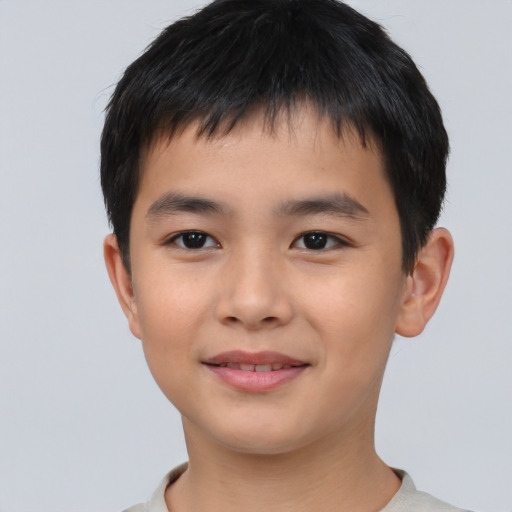 Joyful asian child male with short  brown hair and brown eyes