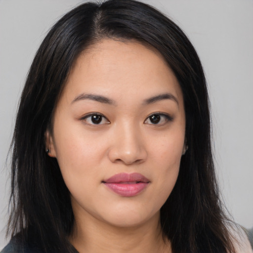 Joyful asian young-adult female with long  black hair and brown eyes