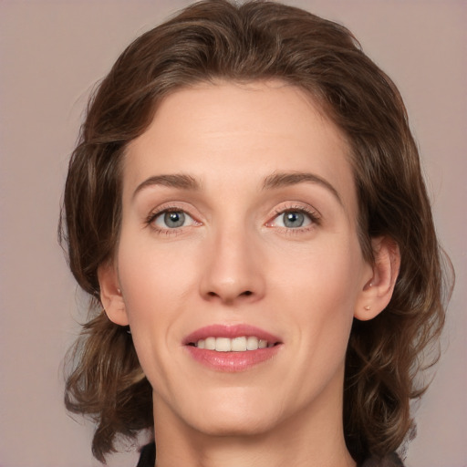 Joyful white young-adult female with medium  brown hair and green eyes