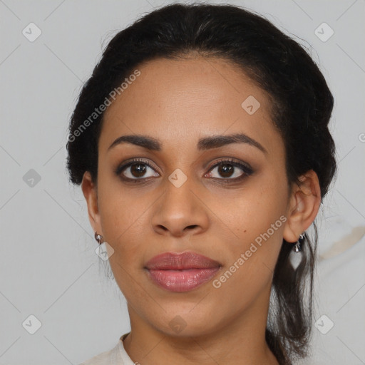 Joyful black young-adult female with long  black hair and brown eyes