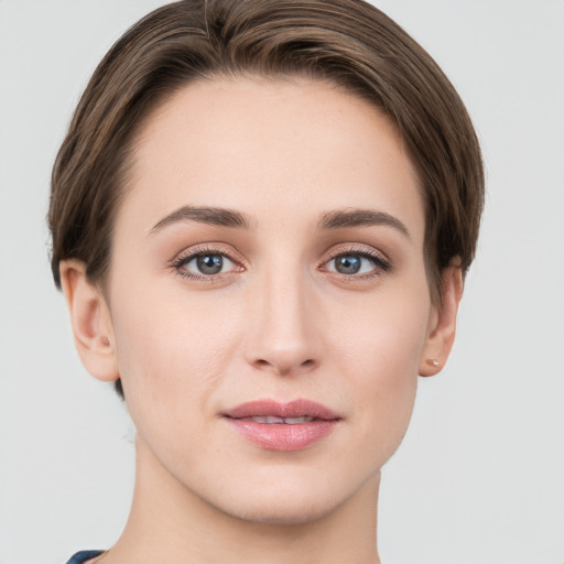 Joyful white young-adult female with short  brown hair and grey eyes