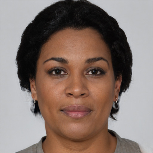 Joyful latino adult female with short  brown hair and brown eyes