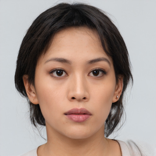 Neutral asian young-adult female with medium  brown hair and brown eyes