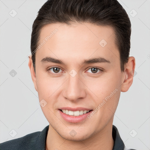 Joyful white young-adult male with short  brown hair and brown eyes