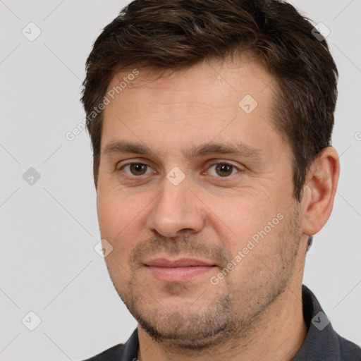 Joyful white adult male with short  brown hair and brown eyes