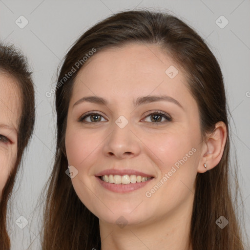 Joyful white young-adult female with long  brown hair and brown eyes